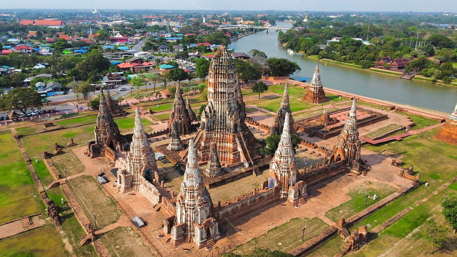 Aerial view of the ruined prangs of Wat Chaiwatthanaram in Ayutthaya beside the river