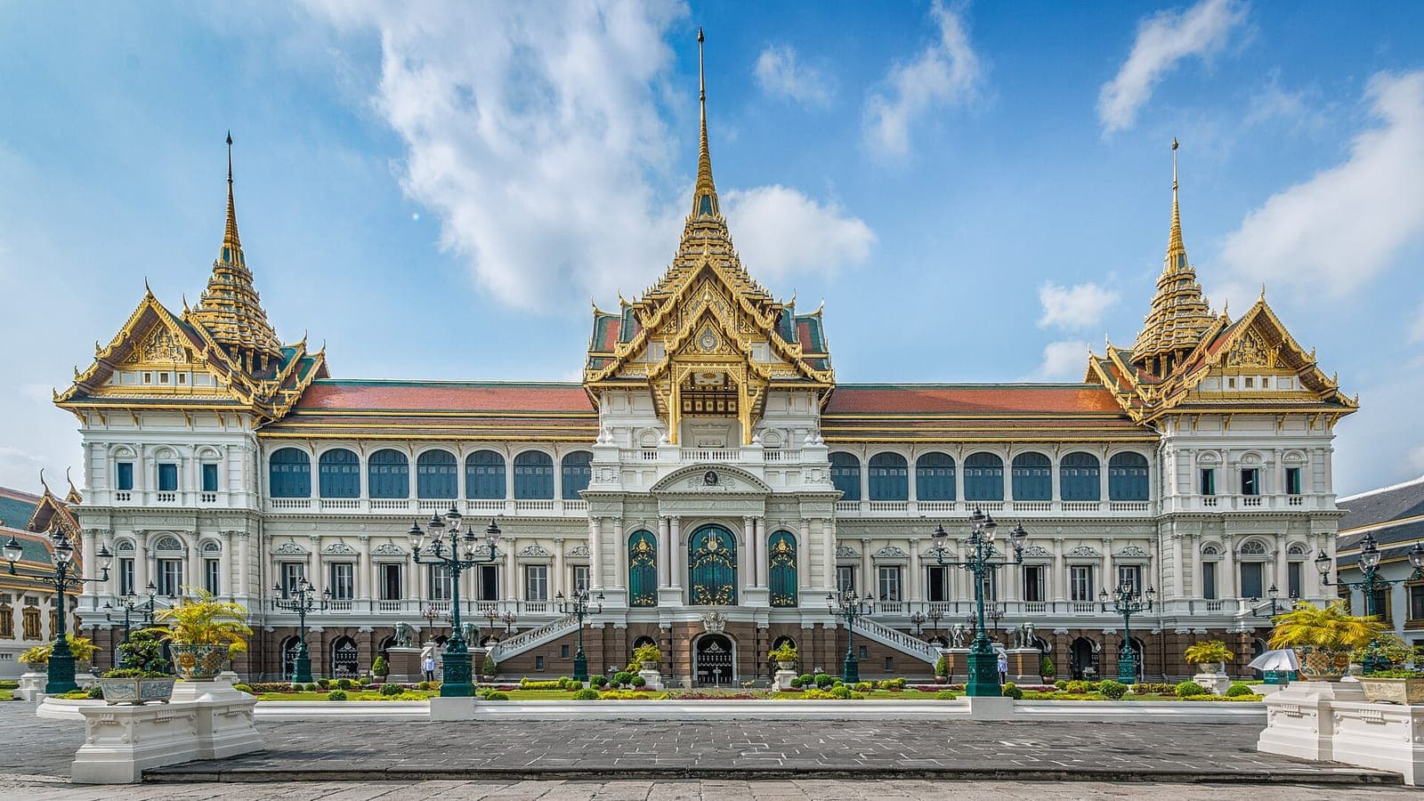 Chakri Maha Prasat Hall of the Grand Palace in Bangkok under a blue sky with white clouds